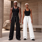 Homme et femme portant le jean à strass unisexe DIFFERENT en noir et en blanc avec ceinture assortie et débardeurs noirs – DIFFERENT Paris