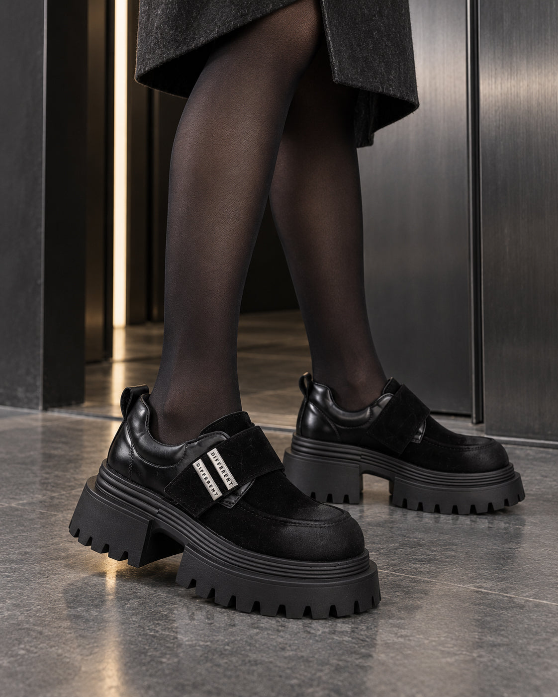 Chaussures à plateforme noires DIFFERENT portées avec collants noirs, vue de côté – DIFFERENT Paris