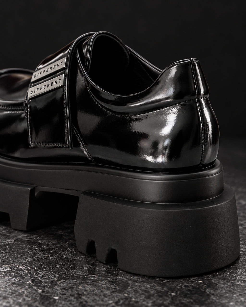 Gros plan arrière de la chaussure plateforme femme noir brillant DIFFERENT, talon et plaques argentées – DIFFERENT Paris